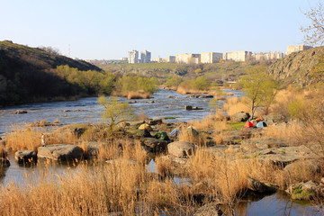 Spring landscape with river, stones and trees
