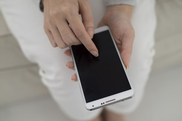 The hands of women who are using smartphones
