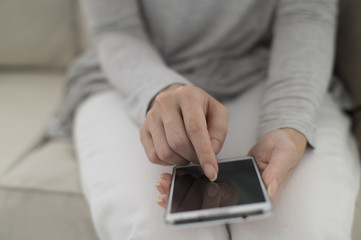 The hands of women who are using smartphones