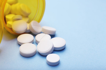 Heap of pills on color background