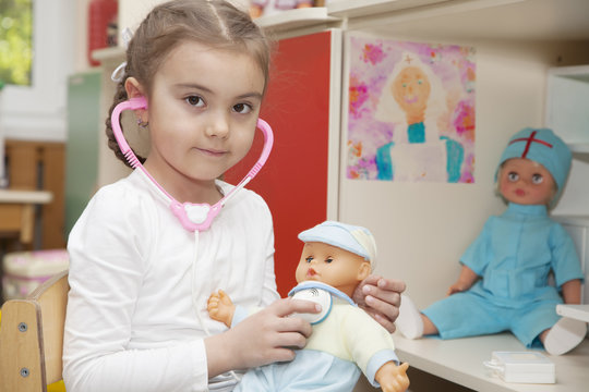 Caucasian little girl playing doctor