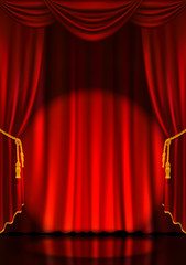 Theater stage with red curtains and spotlight.