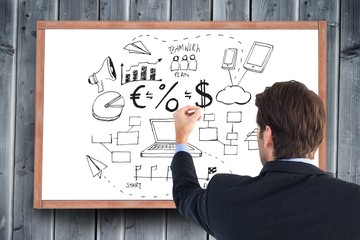 Rear view of businessman writing with a white chalk