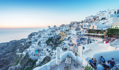 SANTORINI - JULY 11, 2014: People wait for sunset time in Oia to