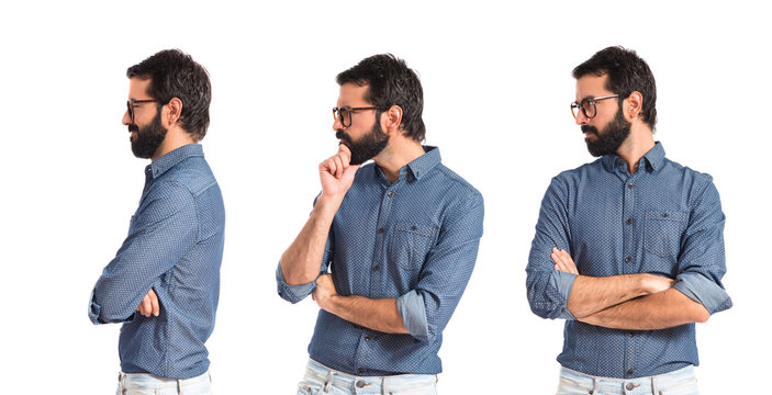 Young hipster man thinking over white background