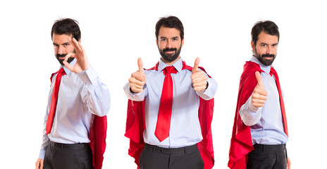 Businessman dressed like superhero making Ok sign © luismolinero