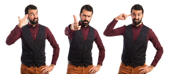 Man wearing waistcoat making gun gesture