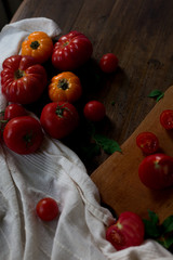 mix of fresh organic red yellow cherry tomatoes rustic dark wood