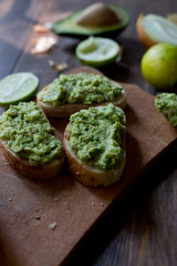 preparation guacamole ingridients on table lime, onion, avocado