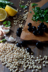 pesto preparation ingredients basil, garlic, lemon, pine, olives