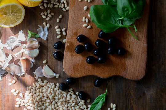 pesto preparation ingredients basil, garlic, lemon, pine, olives