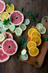 Obraz na płótnie Canvas citrus mix lemon grapefruit lime orange wood rustic background
