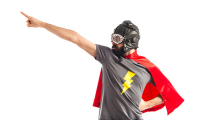Super hero pointing to the lateral - obrazy, fototapety, plakaty