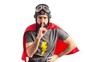 Superhero making silence gesture