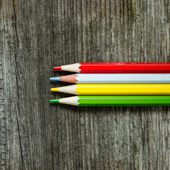 color pencils on wooden background