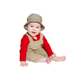 Excited baby explorer/farmer sits on white background