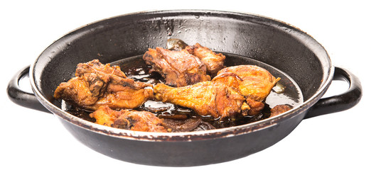 Deep fried chicken in with black soy gravy in a saute pan