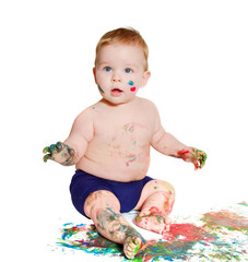 portrait of baby playing with bright colors, getting messy 