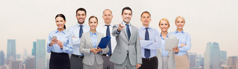 group of happy business people pointing at you