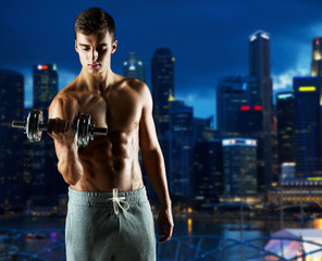 young man with dumbbell flexing biceps