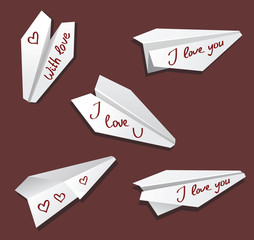 Origami paper airplane toy white on red labeled I love you