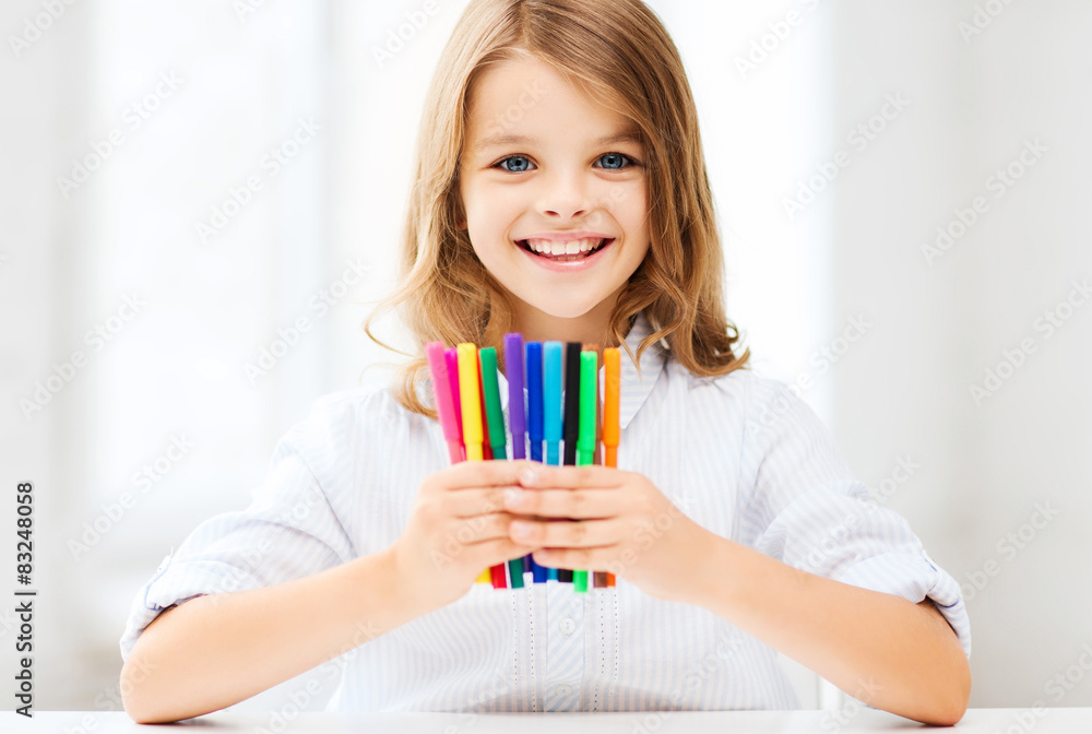 Wall mural girl showing colorful felt-tip pens