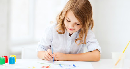 little girl painting at school