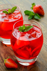 Cold strawberries drinks with strawberry slices and mint