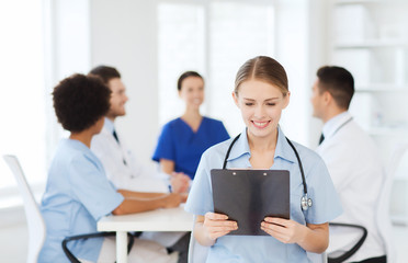 happy doctor over group of medics at hospital