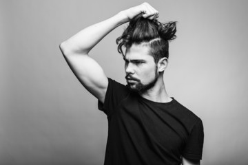 Young man in  black T-shirt with fashionable hairstyle