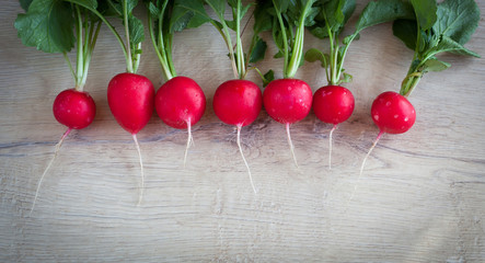 Bunch of fresh radishes on old wooden table - organic food
