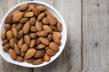 Almond nuts on wood background