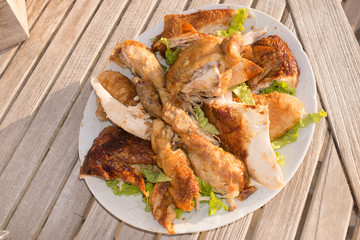 Piece of Roast chicken under wooden background
