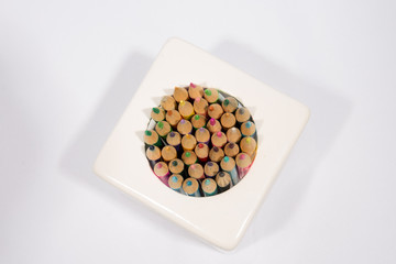 Colorful pencils in pail isolated on white background