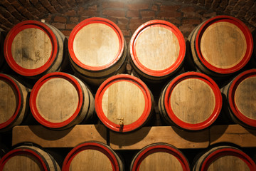 Wine barrels in the antique cellar. Cavernous wine cellar with