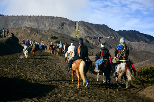 Tourists ride the horses to the crater of Mount Bromo