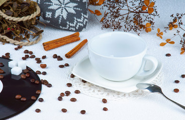 Empty cup among coffee beans