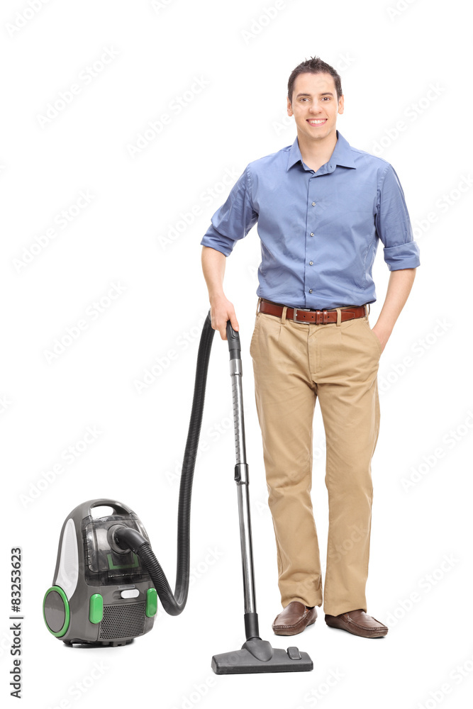 Poster Young casual man posing with a vacuum cleaner