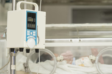 Infusion pump feeding IV drip into baby's patients