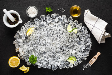Food ingredients  and crushed ice on black table