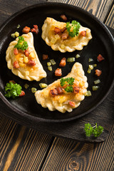 Fried dumplings with onion and bacon top view