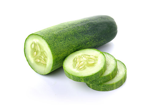 Cucumber and slices isolated over white background.