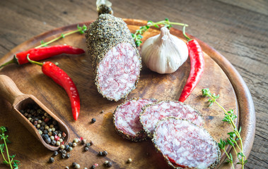 Slices of saucisson on the wooden board