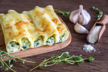 Cannelloni with ricotta and spinach on the wooden board