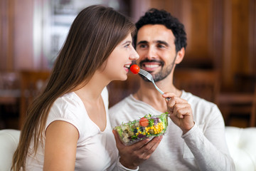 Young couple eating salad