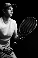 Tennis player on black background. Studio shot