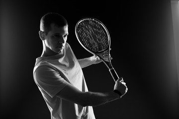 Tennis player on black background. Studio shot