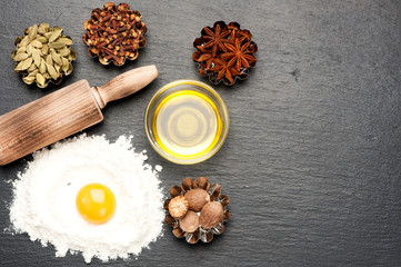 baking background with raw egg, flour, rolling pin, spices