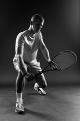 Tennis player on black background. Studio shot