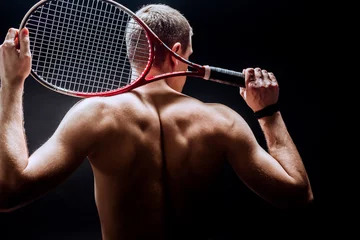 Poster  Tennis player on black background. Studio shot © fotofabrika